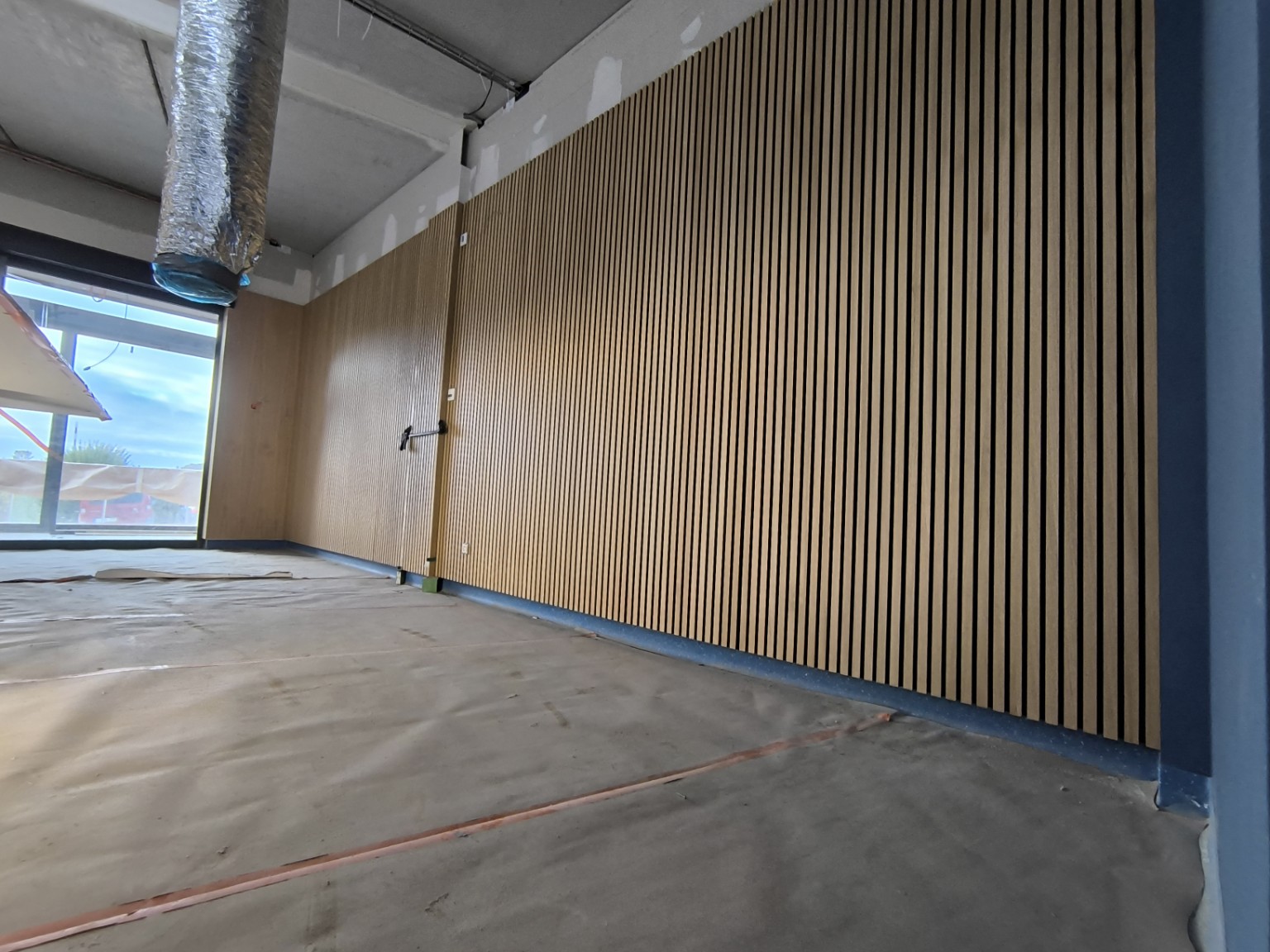 Timber slatted wall installation in progress